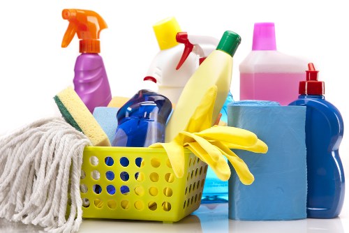 Trained cleaner using carpet cleaning tools with protective gloves